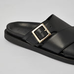 Close-up of black Llafranc leather sandal with metal buckle detail