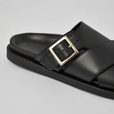 Close-up of black Llafranc leather sandal with metal buckle detail