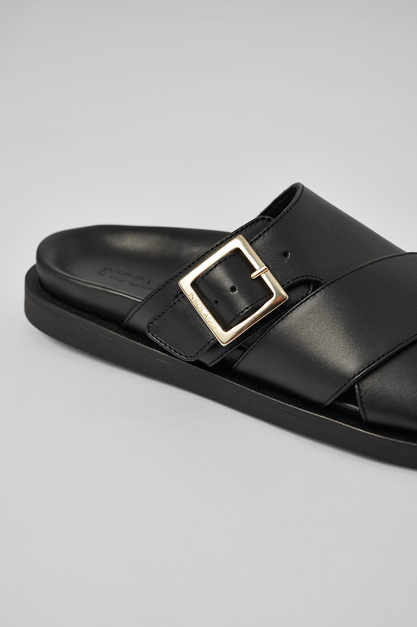 Close-up of black Llafranc leather sandal with metal buckle detail
