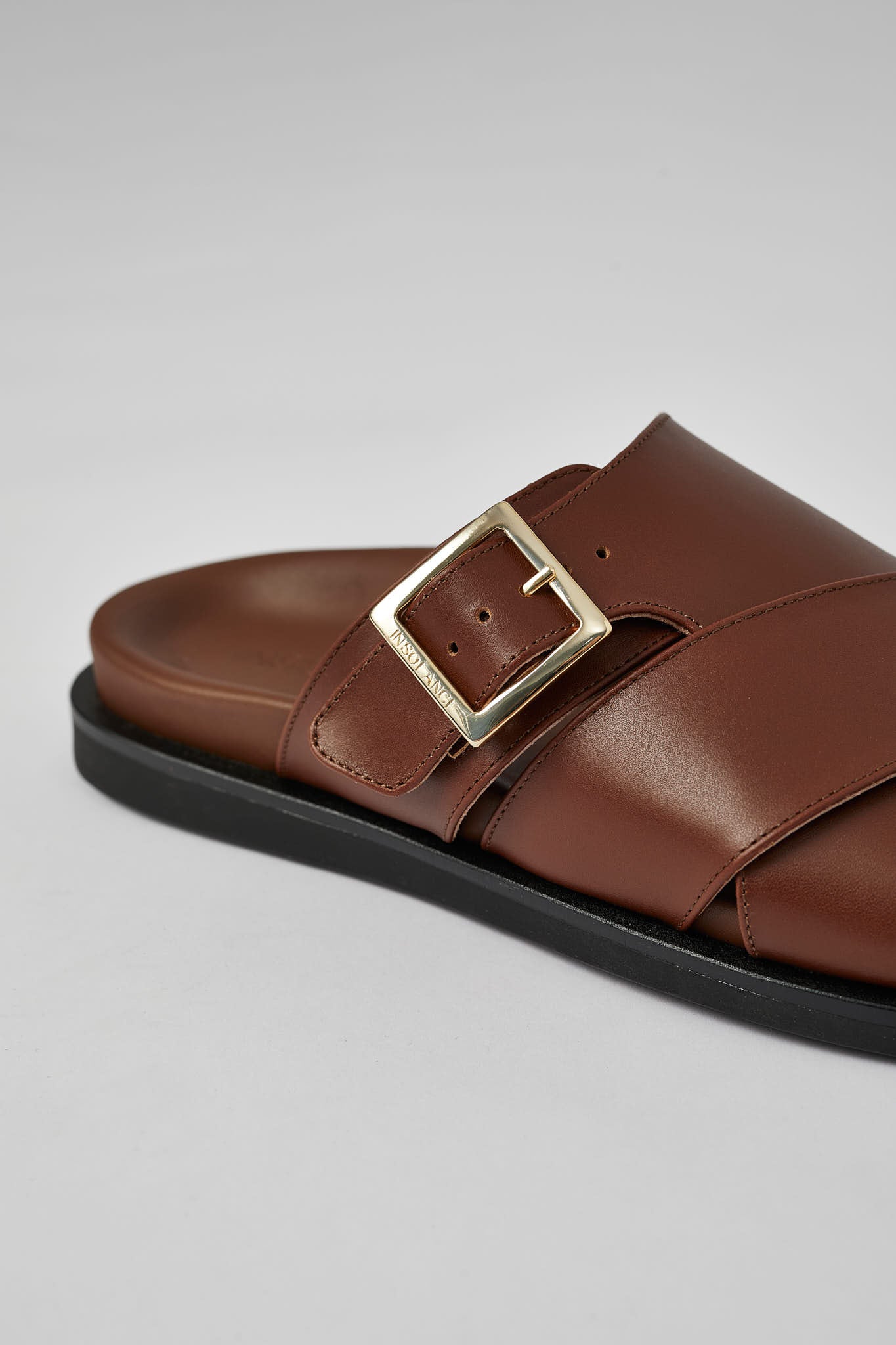 Close-up of brown Llafranc leather sandal with buckle detail