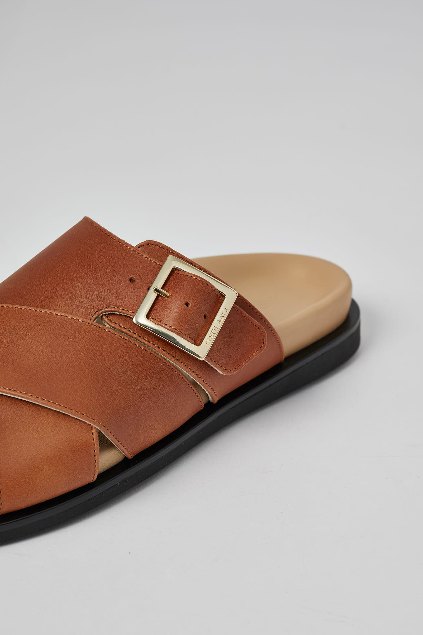 Close-up of tan Llafranc leather sandal with metal buckle