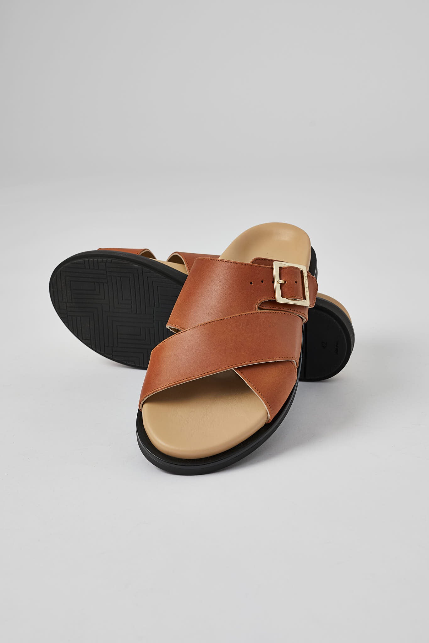 Tan Llafranc handcrafted leather sandal with black sole and adjustable buckle