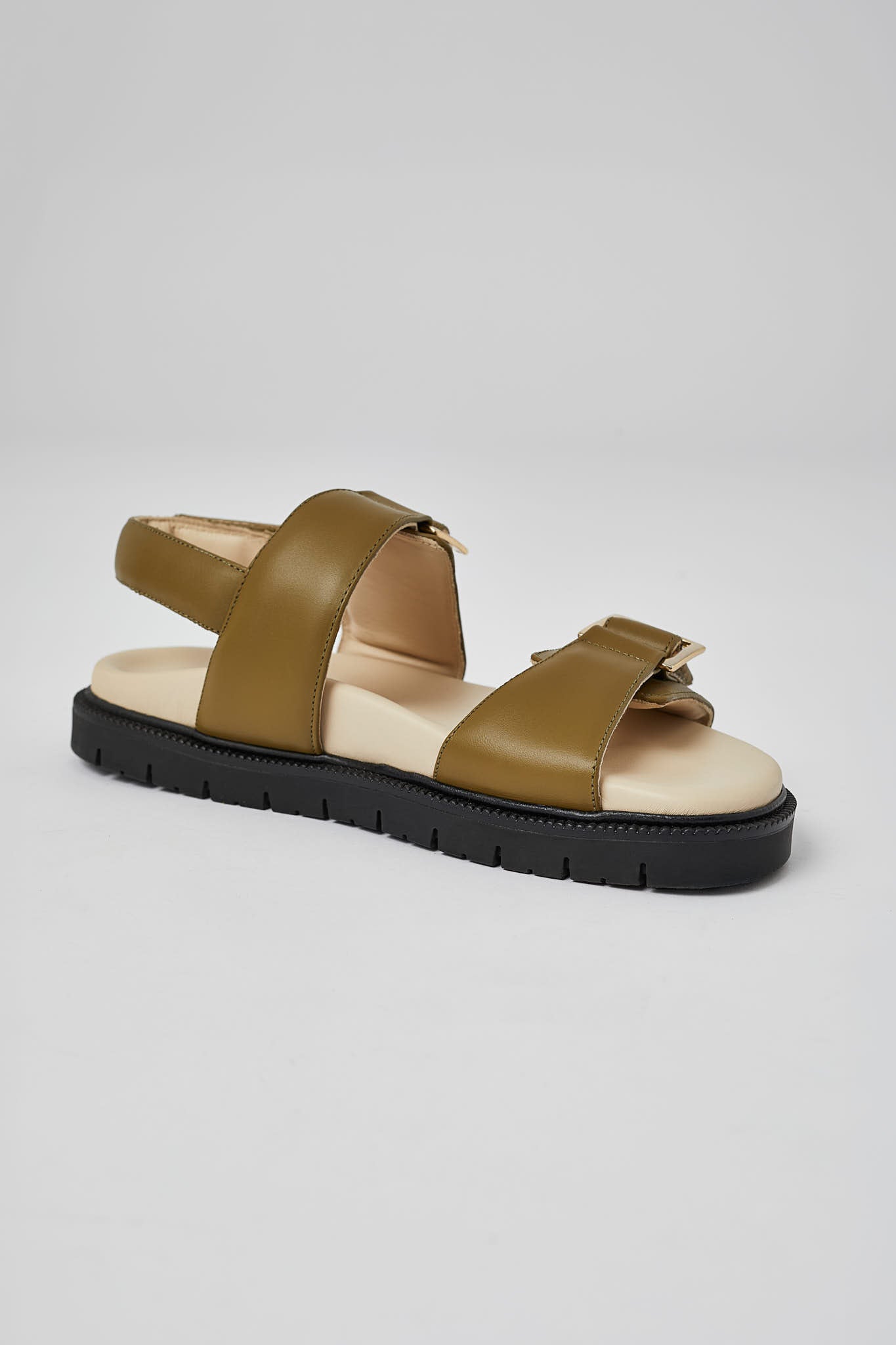 Close-up of olive Barna leather sandal with gold buckle and sole
