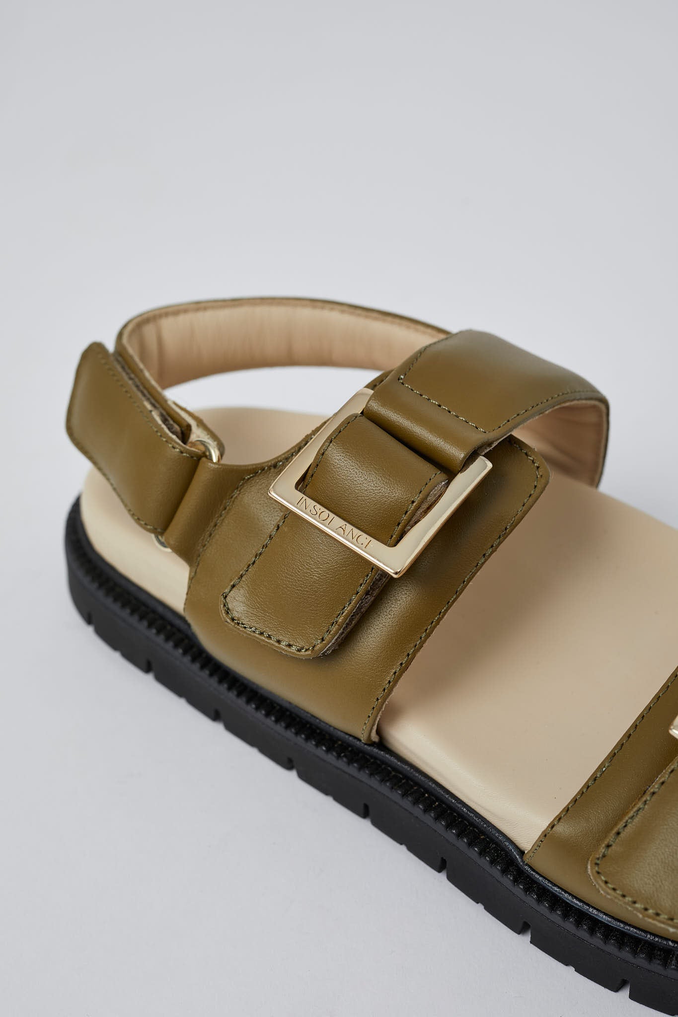 Olive Barna leather sandals angled view with gold buckles