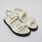 White Barna leather sandal side view with gold buckle detail