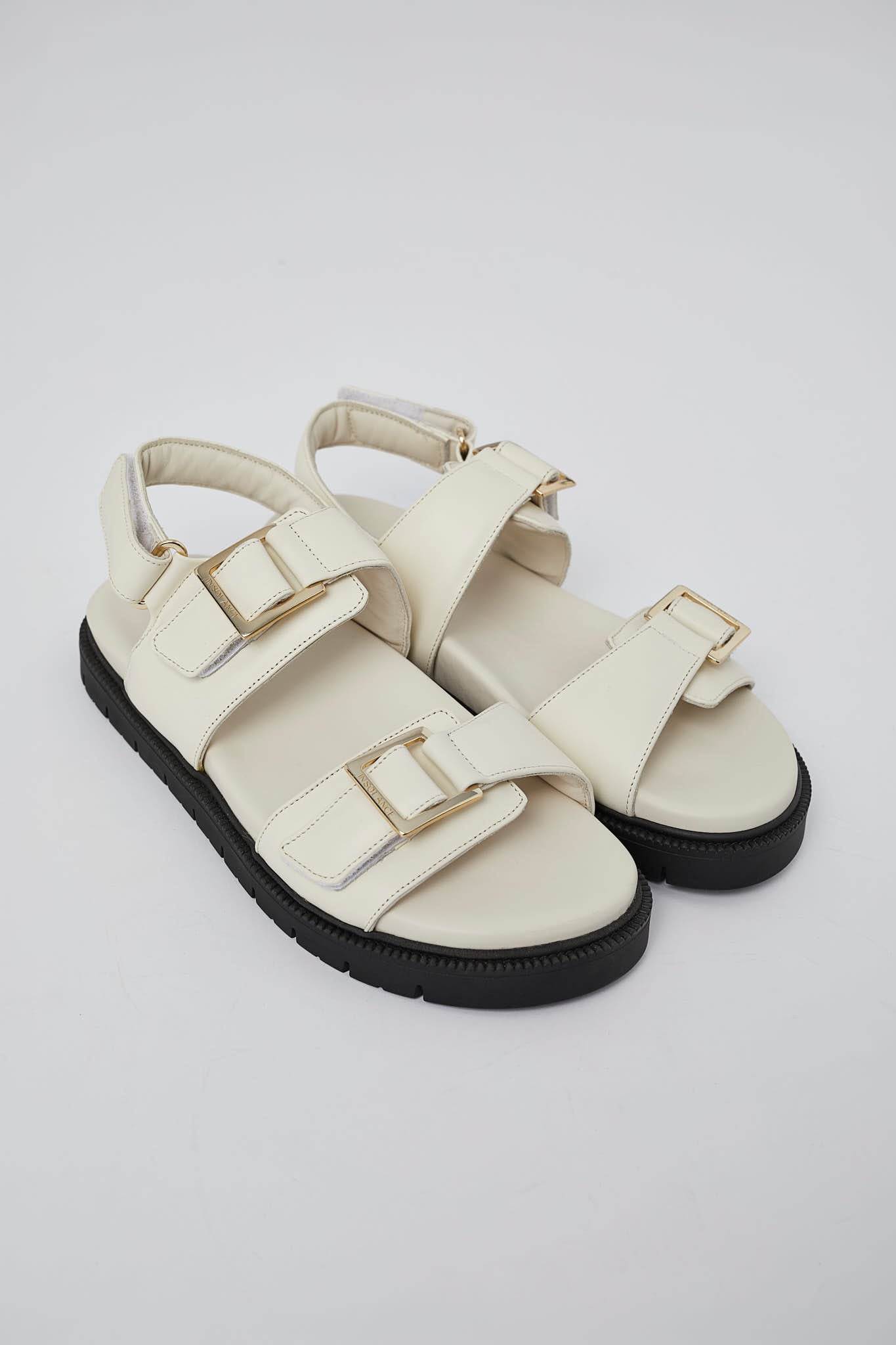 White Barna leather sandal side view with gold buckle detail