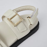 White Barna leather sandals angled view with gold buckles