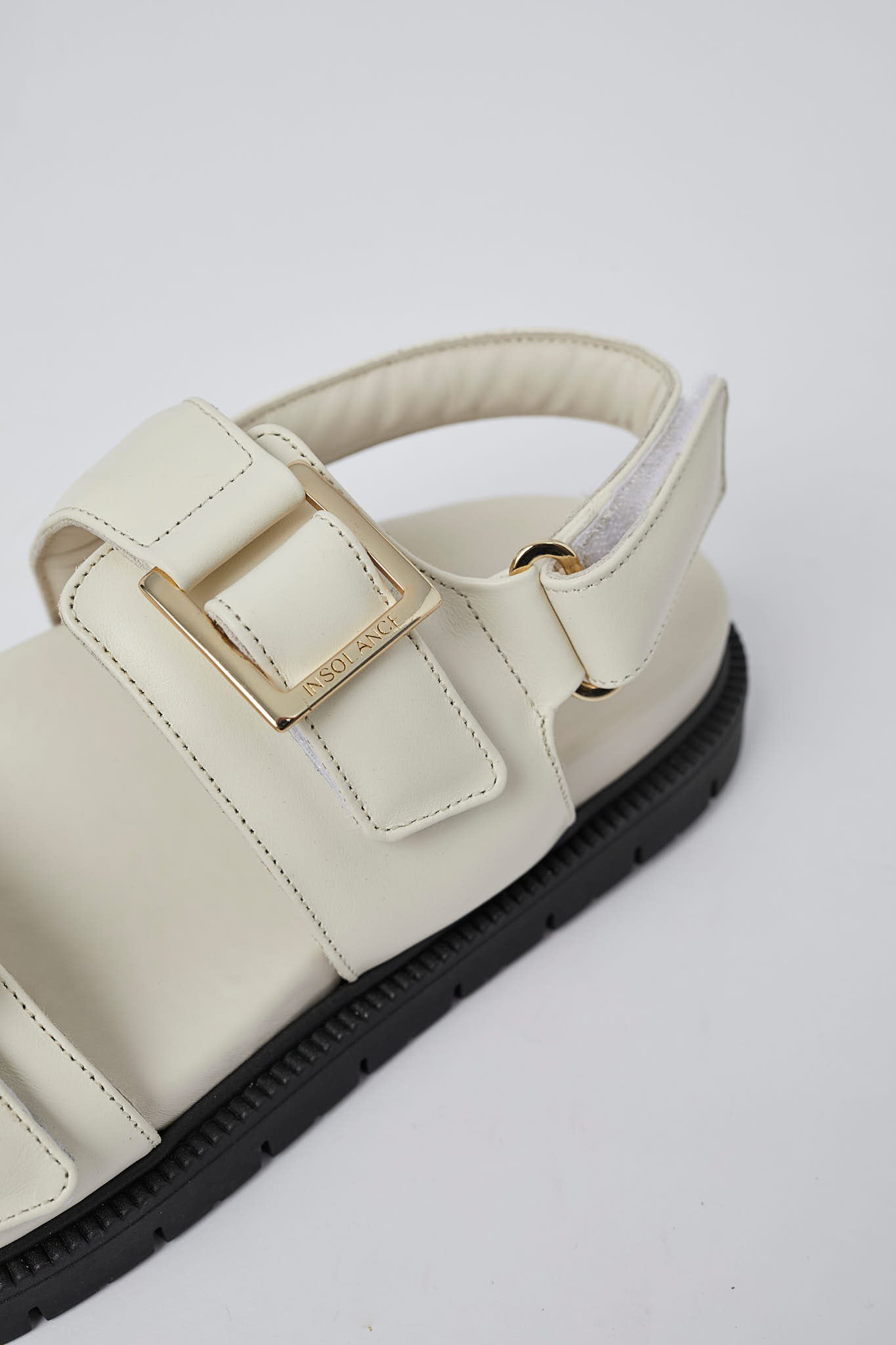 White Barna leather sandals angled view with gold buckles
