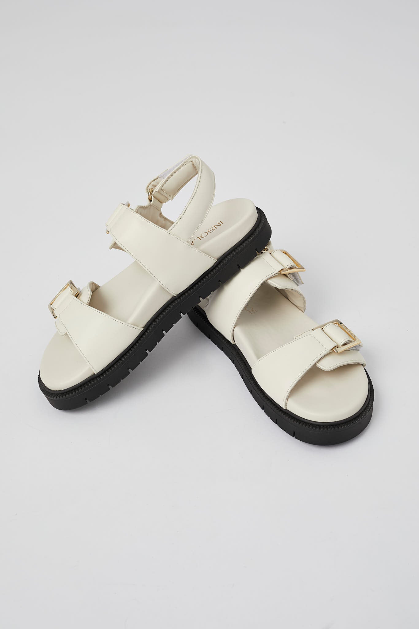 White Barna handcrafted leather sandals with gold buckles